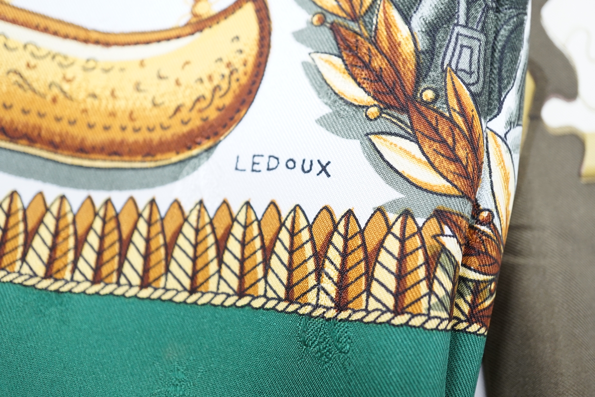 Four vintage Hermes silk scarves including two retailed by Harrods comprising Cuivreries, Roues de Canon, Napoleon and Puzzle